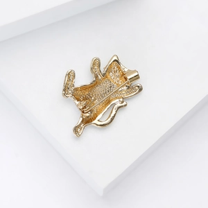 Detailed back view of golden cat brooch showing secure metal safety pin and textured alloy