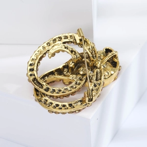 Close-up of the vintage gold snake brooch back showing the pin fastener and crystal edges