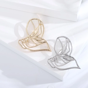 Minimalist hollow butterfly brooches in gold and silver finish on white background