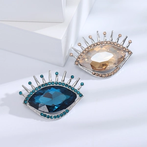 Broches élégantes en cristal en forme d'œil avec strass bleu foncé et doré champagne