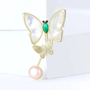 Elegant gold butterfly brooch with shell inlay, green gemstone and pink pearl drop