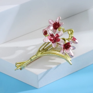 Elegant enamel orchid brooch featuring pink gradient petals and golden alloy stem detail