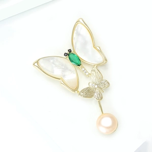 Elegant gold butterfly brooch with iridescent shell wings, green gem, and pink pearl drop