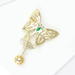Detailed back view of double butterfly brooch showing pin clasp and pearl pendant