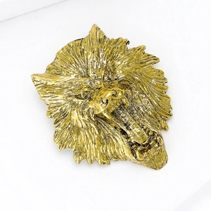 Close-up of golden lion head brooch with detailed mane texture and fierce expression