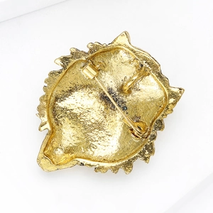 Macro shot showing the gold lion head brooch back with safety pin and pendant loop