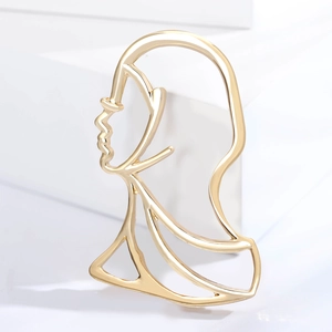 Elegante spilla dorata traforata profilo donna minimalista accessorio per abito cappotto