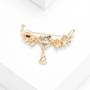 Detail view of the gold alloy heart wing brooch showing the secure back pin clasp mechanism