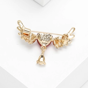 Elegant heart and golden wings brooch with crystal bell pendant and premium metal finish