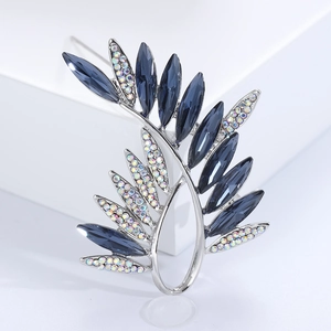 Detailed view of olive branch brooch with navy blue crystals and AB rhinestones on silver base