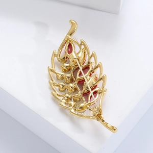 Detailed back view of golden leaf brooch showing secure pin fastener and smooth metal finish
