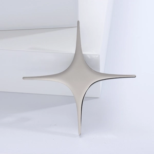 Macro shot of silver minimalist cross star brooch on white geometric display stand