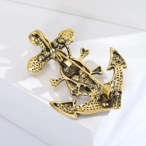 Detailed back view of vintage gold anchor brooch showing secure safety pin and metallic texture