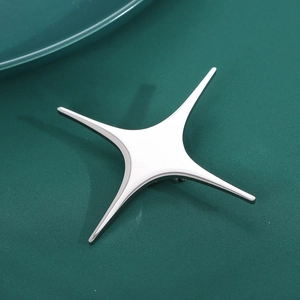 Minimalist silver four-pointed star brooch for suits, elegant cross star pin on dark background