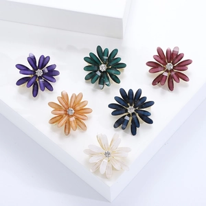 Elegant daisy flower brooches set with translucent petals and sparkling center crystals