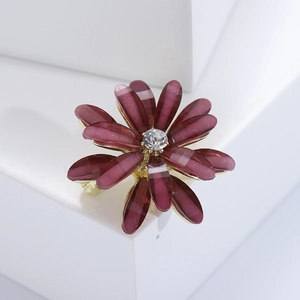 Close-up of elegant purple floral brooch with alloy base and sparkling crystal center