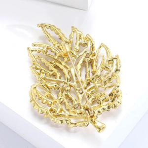 Detail view showing the back pin mechanism of the gold leaf brooch with hollow leaf veins