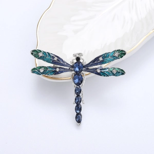 Detailed macro view of the dragonfly brooch with blue enamel and sparkling rhinestones