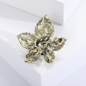 Detailed back view of vintage gold flower brooch showing security pin clasp and texture