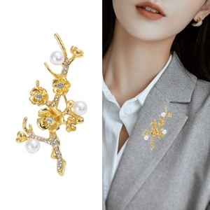 Elegant vintage gold floral branch brooch with pearls and crystals on female model