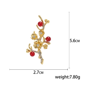 Elegant vintage alloy plum blossom brooch with red pearls and crystals, size 5.6cm by 2.7cm