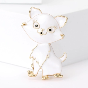 Detailed close-up of a cartoon cat enamel brooch with gold trim on a white podium