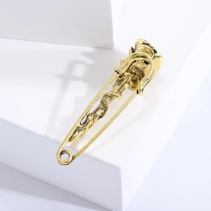 Detailed macro view of vintage rose brooch with antique gold finish on geometric stand