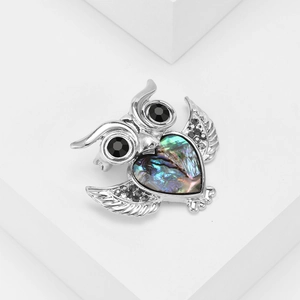 Elegant owl brooch with heart-shaped abalone shell inlay and black crystal eyes