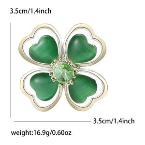 Elegant alloy four-leaf clover brooch with green cat-eye stones and crystal center