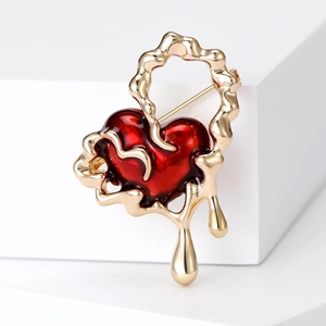 Lava fluid style red heart brooch with golden metal frame in elegant minimalist aesthetic