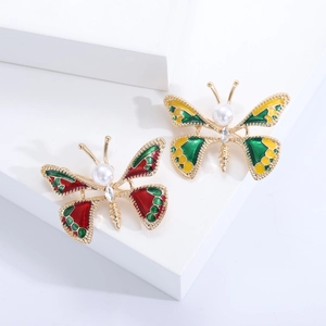 Broches papillon élégantes avec émail rouge, strass brillants et perles blanches