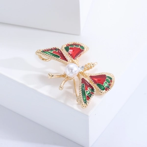 Détails de la broche papillon en émail rouge et vert avec une perle et des cristaux