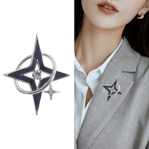 Silver star brooch with blue enamel and crystal on grey suit jacket lapel