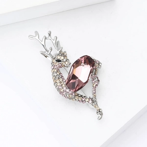 Close-up of silver elk brooch with pink crystals and shimmering rhinestones for women