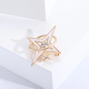 Detailed close-up of a silver star brooch with white enamel and sparkling crystals