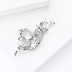 Detailed back view of a silver deer brooch showing the secure rotating safety pin clasp