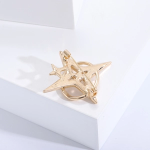 Detail of the rotating safety pin clasp on the back of a golden star brooch