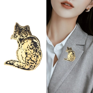 Golden stainless steel cat brooch with black stripe etching on gray suit lapel