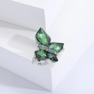 Exquisite green crystal butterfly brooch with rhinestone accents on silver metal base