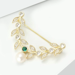 Elegant gold leaf brooch with green gemstone, white zircon leaves and a round pearl