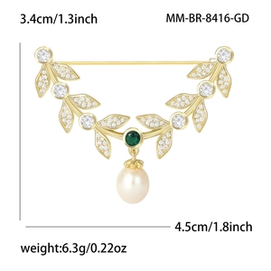Elegant gold leaf brooch with zircon accents, emerald gemstone, and pearl drop pendant