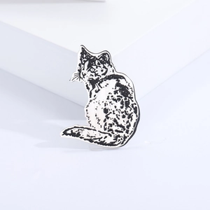 Minimalist silver and black enamel cat lapel pin on a white geometric background