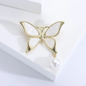 Elegant gold butterfly stud earrings with white mother of pearl inlay and hanging pearl charm