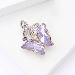 Detailed close-up of luxury purple crystal butterfly brooch with fine zircon inlay work