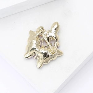 Luxury gold butterfly brooch with purple details showing secure back pin clasp structure
