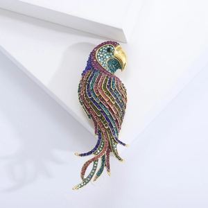Detailed view of parrot brooch with multi-color rhinestones set in gold finish