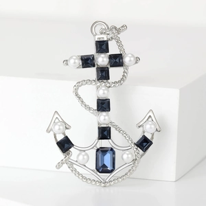 Vintage silver anchor brooch featuring deep blue crystals and round white pearls