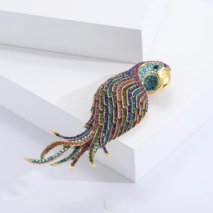 Macro shot of gold parrot brooch encrusted with vibrant multicolor crystals and gems