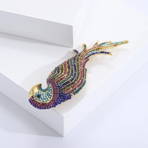 Close-up of a colorful rhinestone parrot brooch with a golden base on a white cube