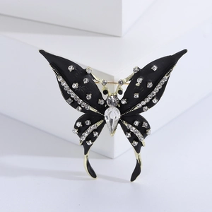 Detailed close-up of a vintage butterfly brooch with black enamel and sparkling rhinestones